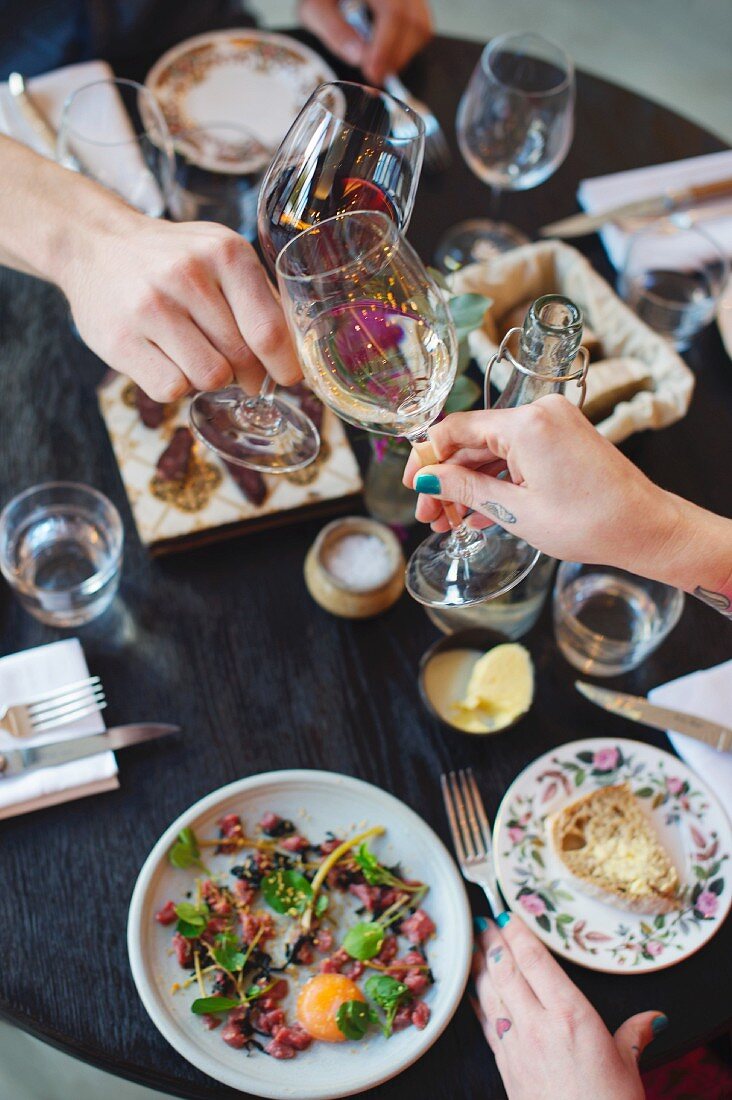 People toasting in the 'Paradise Garage' restaurant, London, England