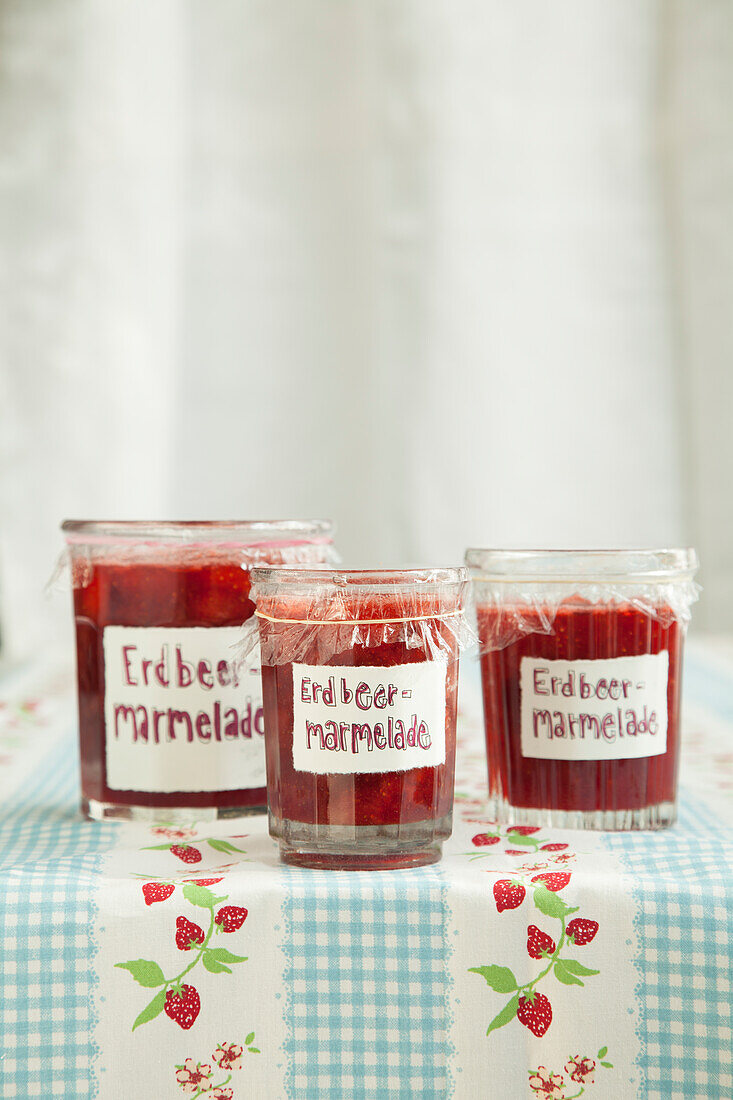 Jars of homemade strawberry jam on a table