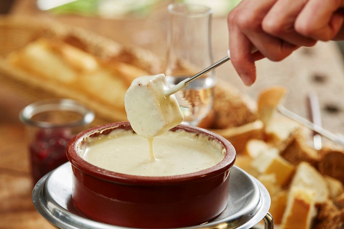 Cheese fondue and pieces of white bread