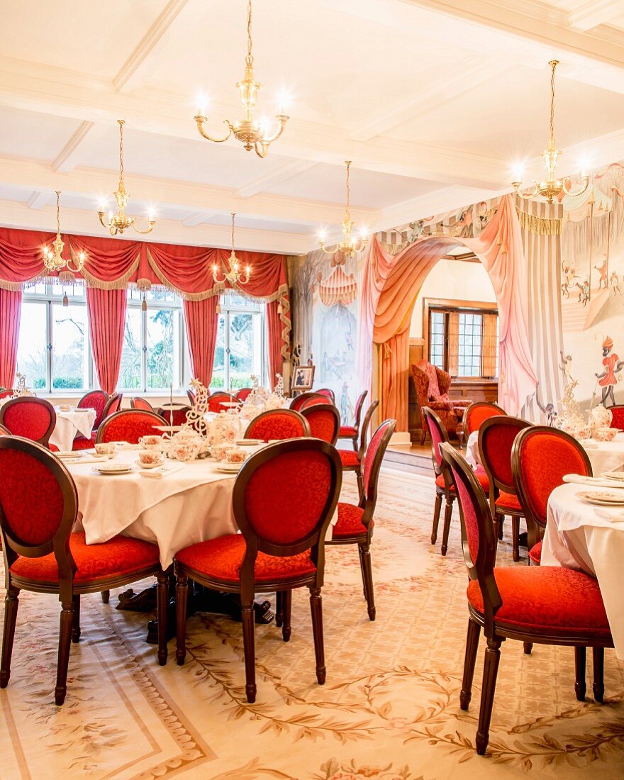 Red medallion chairs in grand, festive dining room