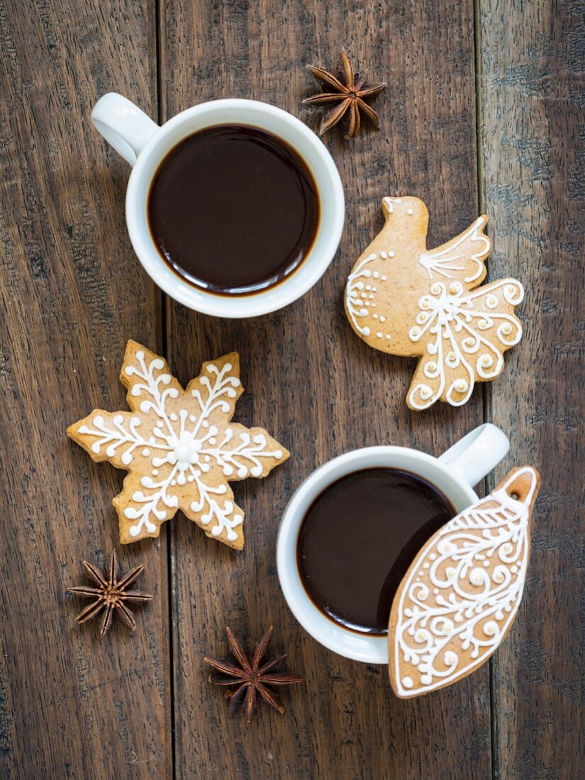 Two cups of coffee served with homemade gingerbread biscuits