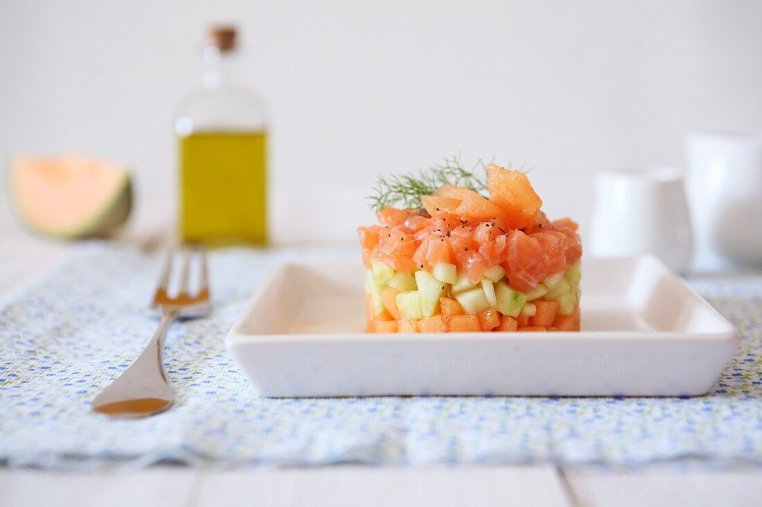 Salmon and cucumber tartare with melon, poppy seeds and dill