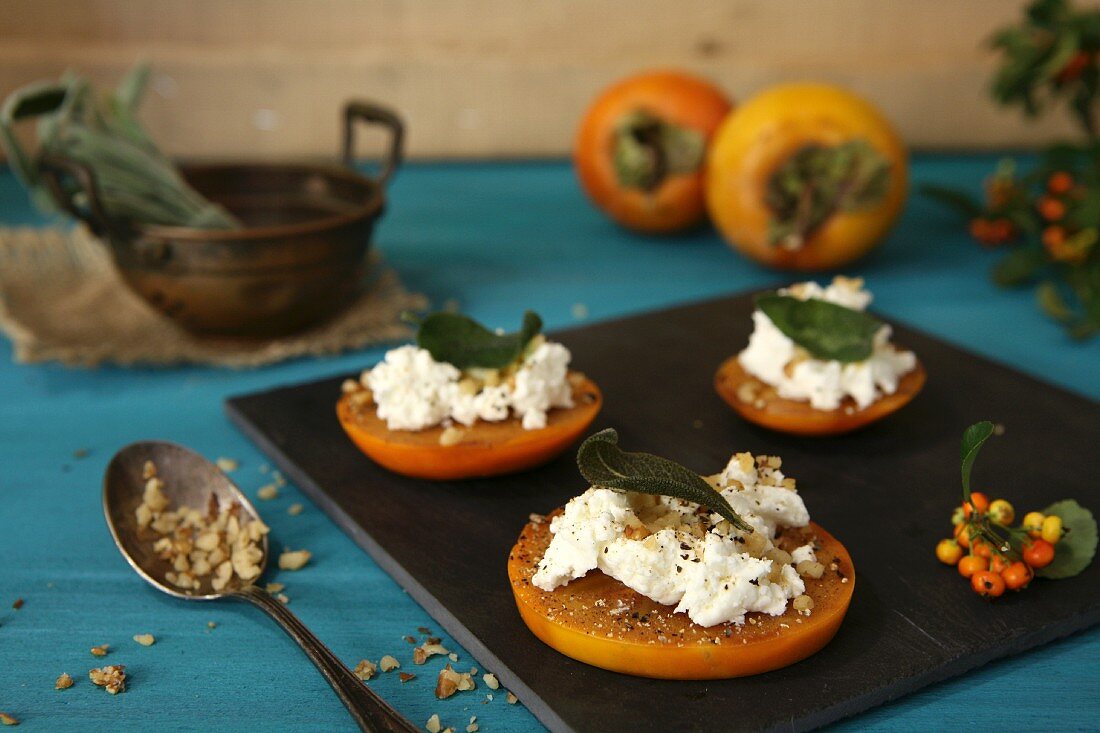 Persimmon slices with goat's cheese, sage, black pepper and hazelnuts