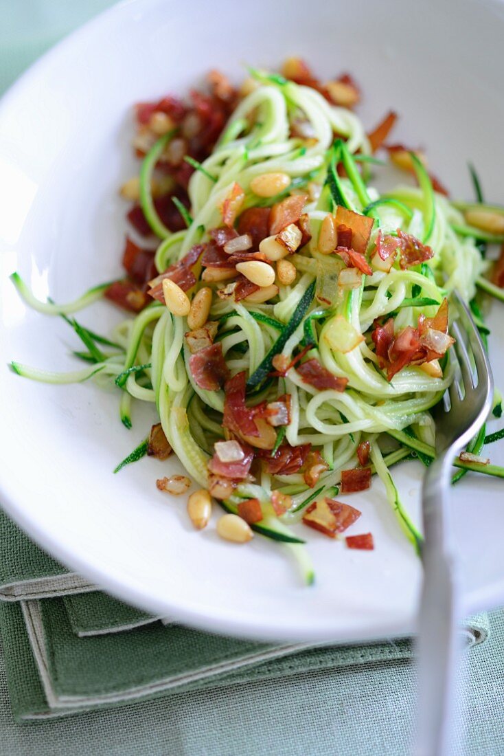 Courgette spaghetti with bacon and pine nuts