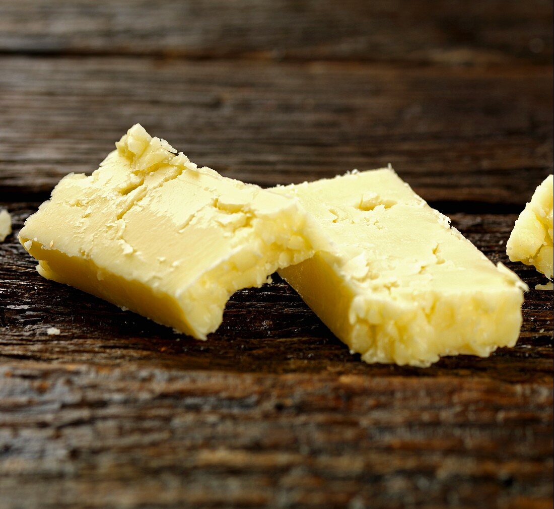 Cheddar cheese on a wooden surface