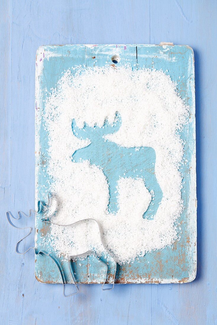 An elk shape in grated coconut with a cutter