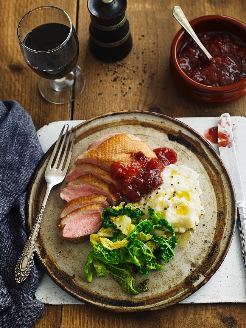 Pan-fried duck breast with savoy cabbage, mashed potatoes and lingonberry jam