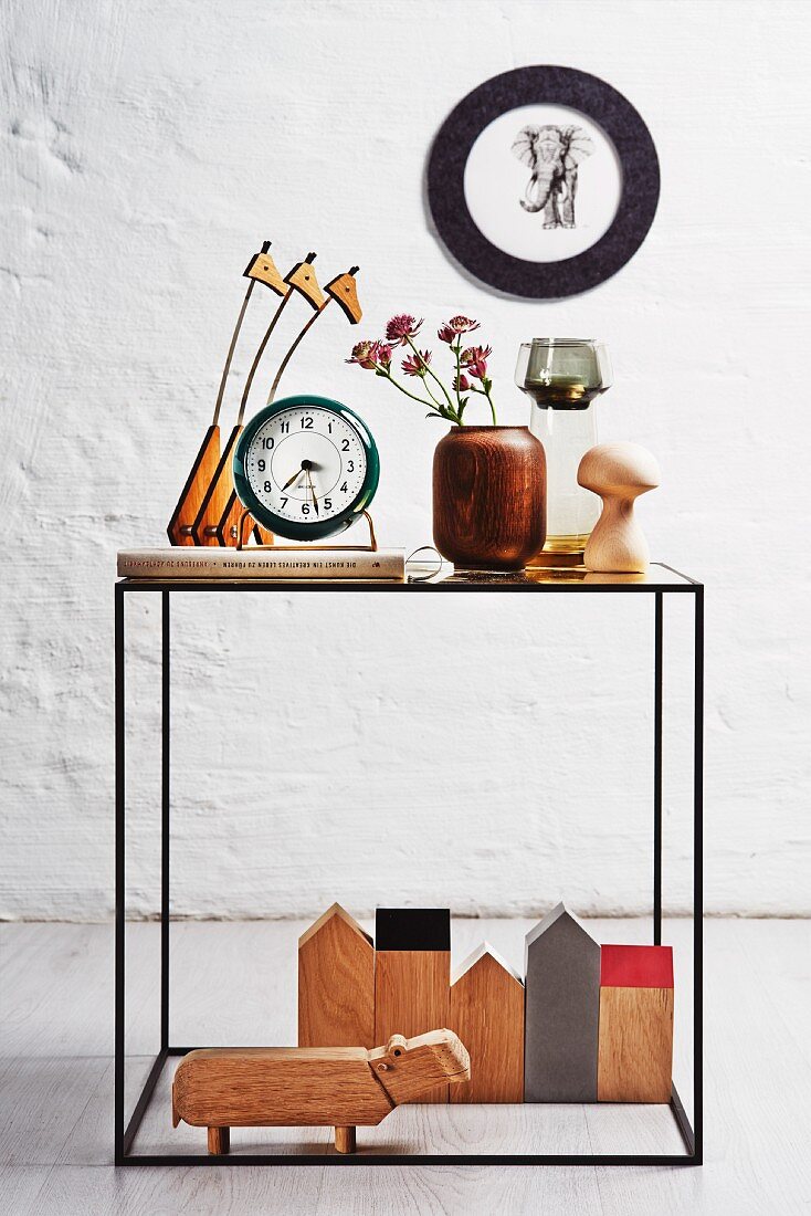 Various wooden ornaments on delicate side table