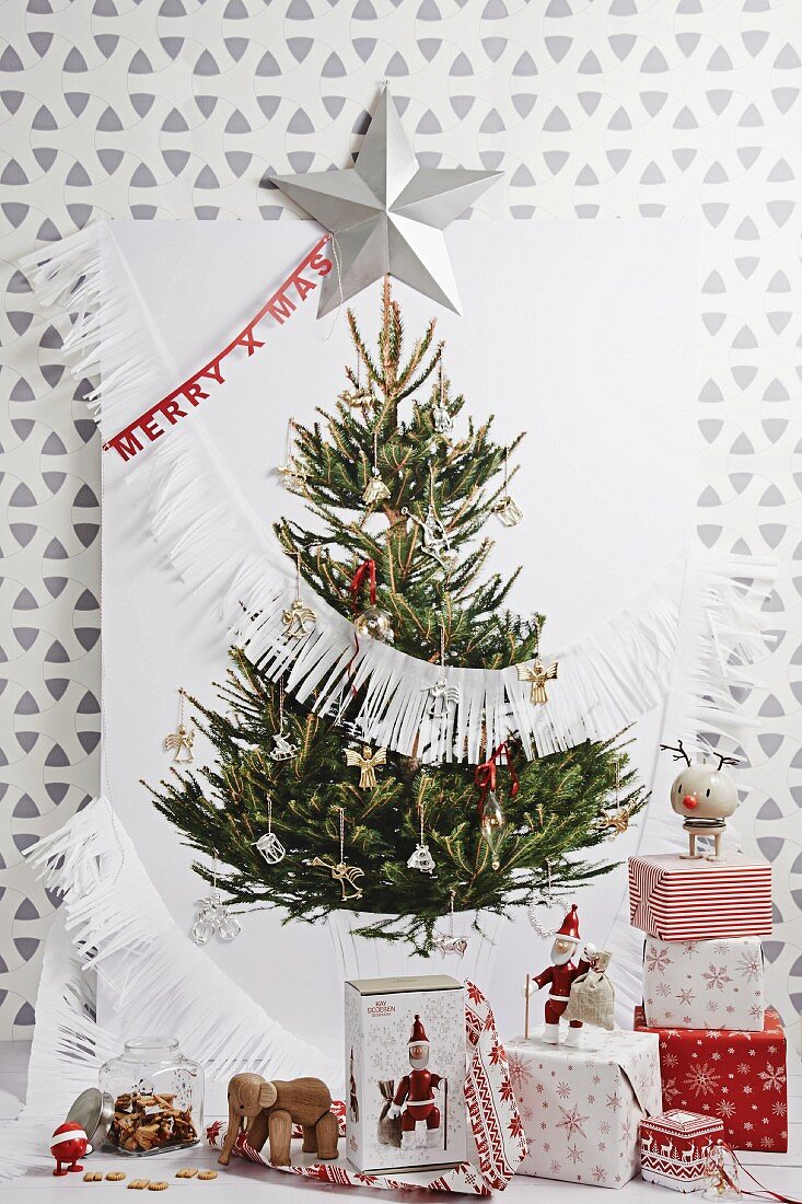 Picture of Christmas tree on wall with wrapped gifts below