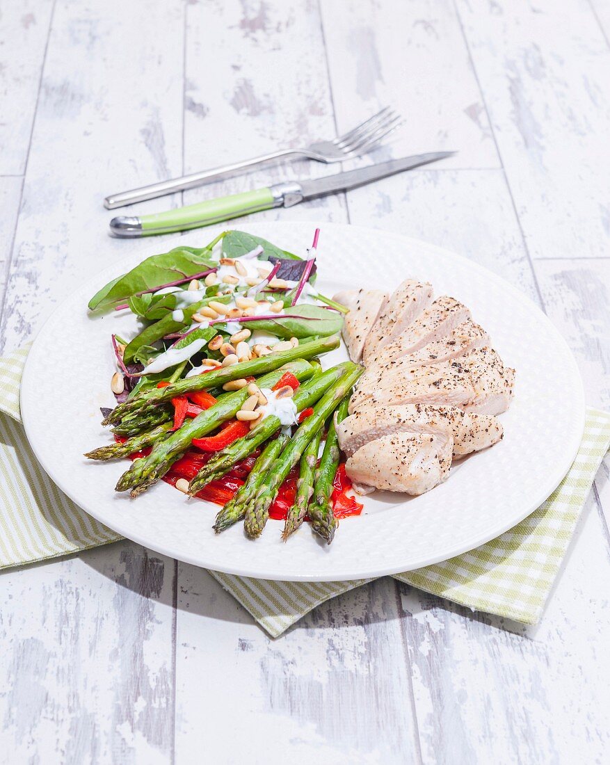 Chicken and asparagus salad with peppers and pine nuts