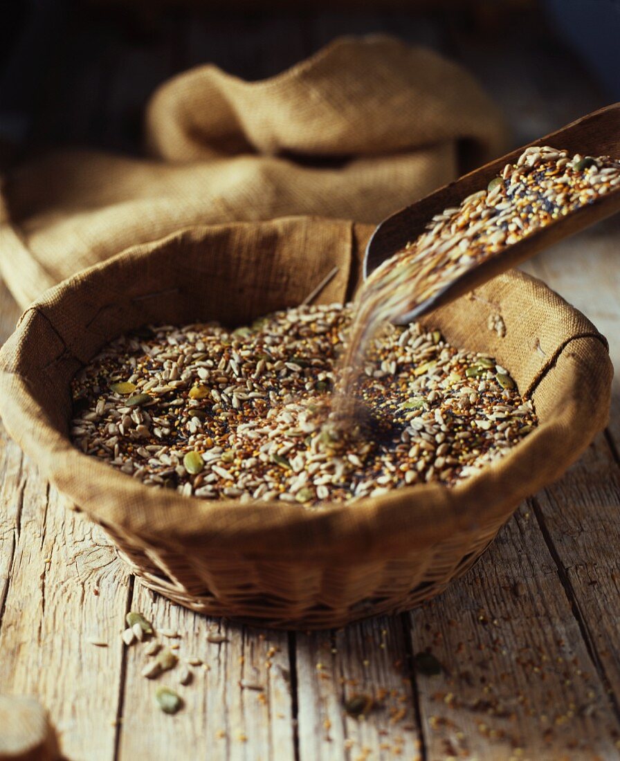 A mixture of seeds for baking bread in a wooden bowl