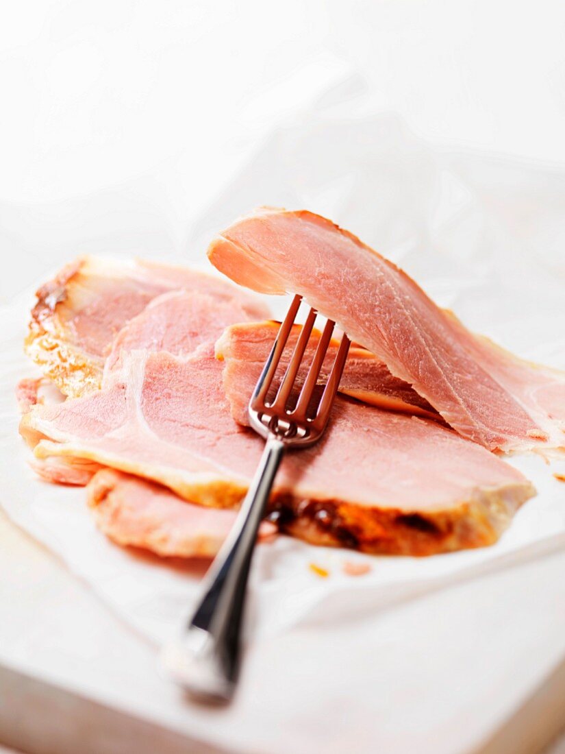 Slices of Wiltshire ham with a fork