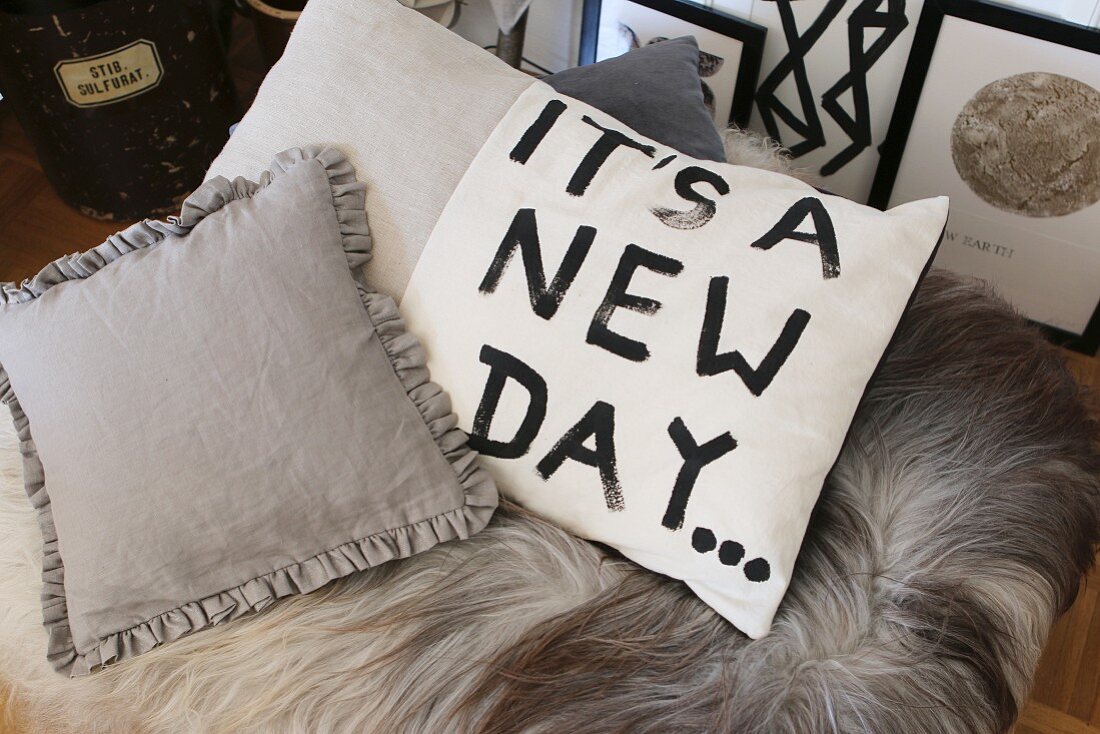Scatter cushion hand-painted with the motto 'It's a new day...'