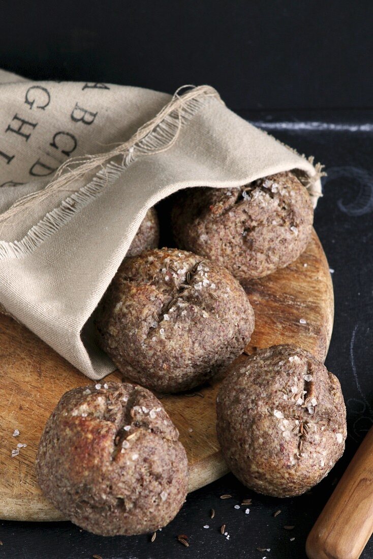 Gluten-free rolls made from flaxseed flower and caraway in a linen bag