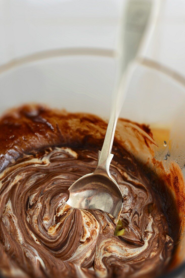 Melted chocolate in a bowl with a spoon