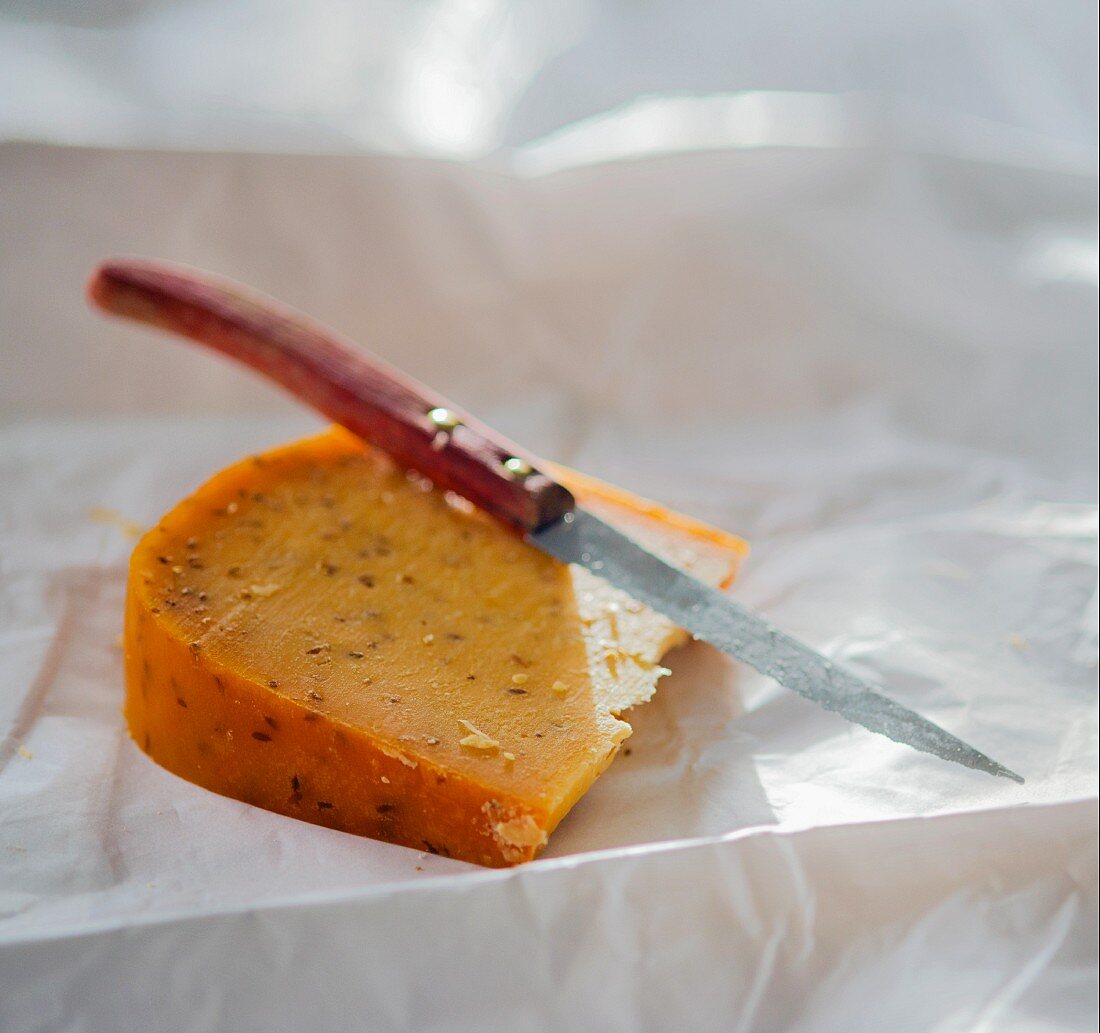 A slice of Gouda with caraway seeds