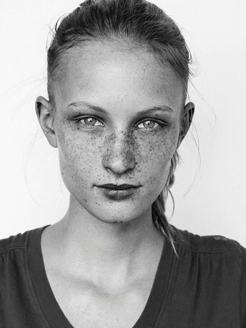 A young blonde woman with lots of freckle (black-and-white shot)