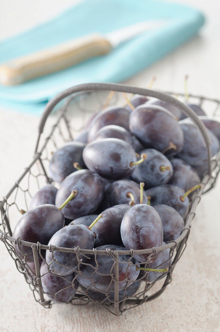 Damsons in a wire basket