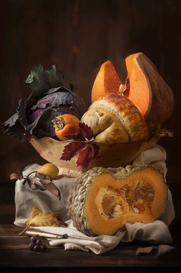An autumnal arrangement featuring pumpkins, cabbage, persimmons and pears