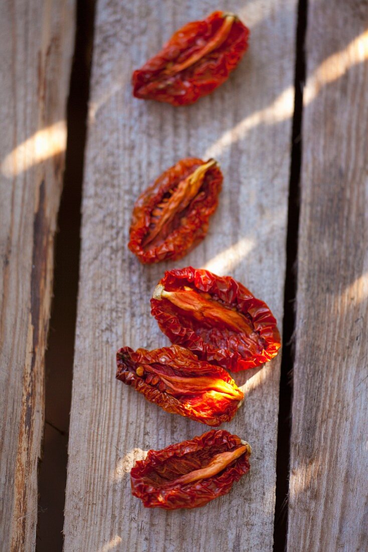 Dried tomatoes on a wooden surface