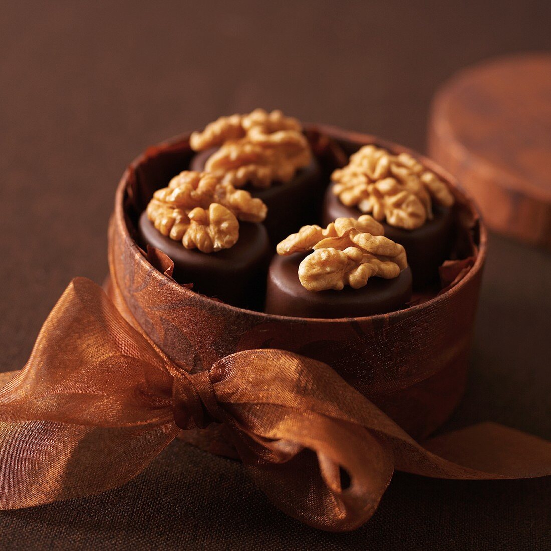 Walnut and marzipan pralines in a round gift box