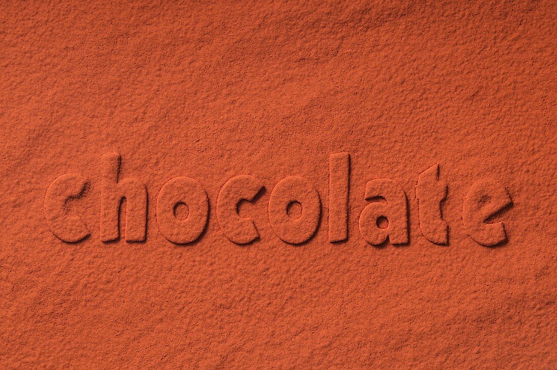 The word 'chocolate' written in cocoa powder