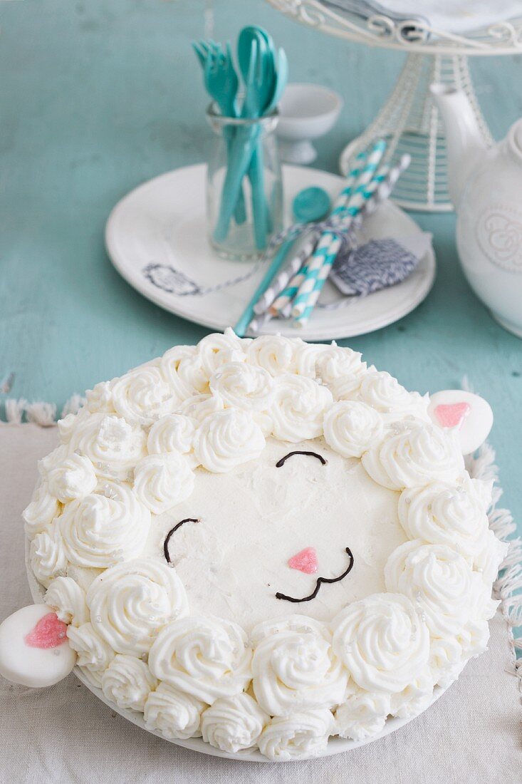 A birthday cake decorated with butter cream for a baby party