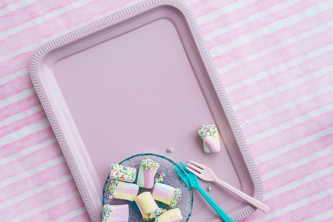 Colourful marshmallows on pink tray