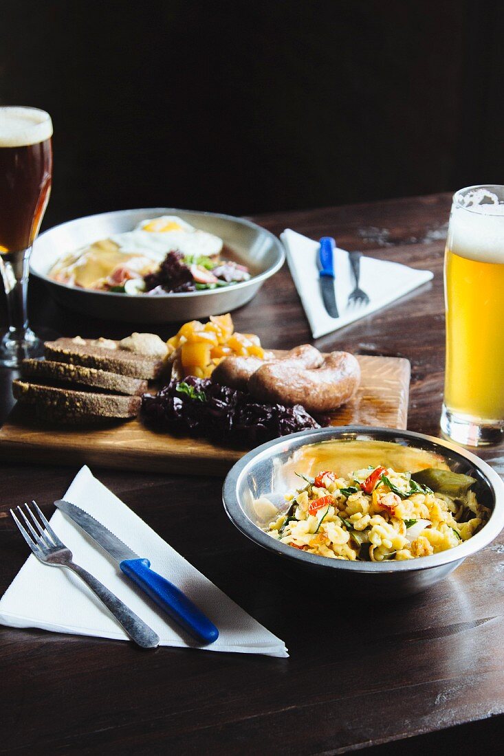 Various dishes and a glass of beer on the table