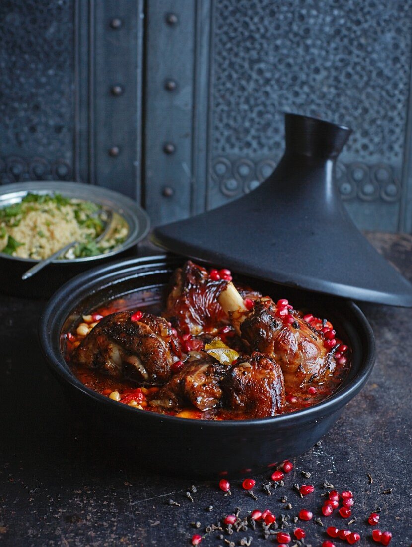 Lamb tagine with pomegranate, cinnamon flowers and orange couscous (North Africa)