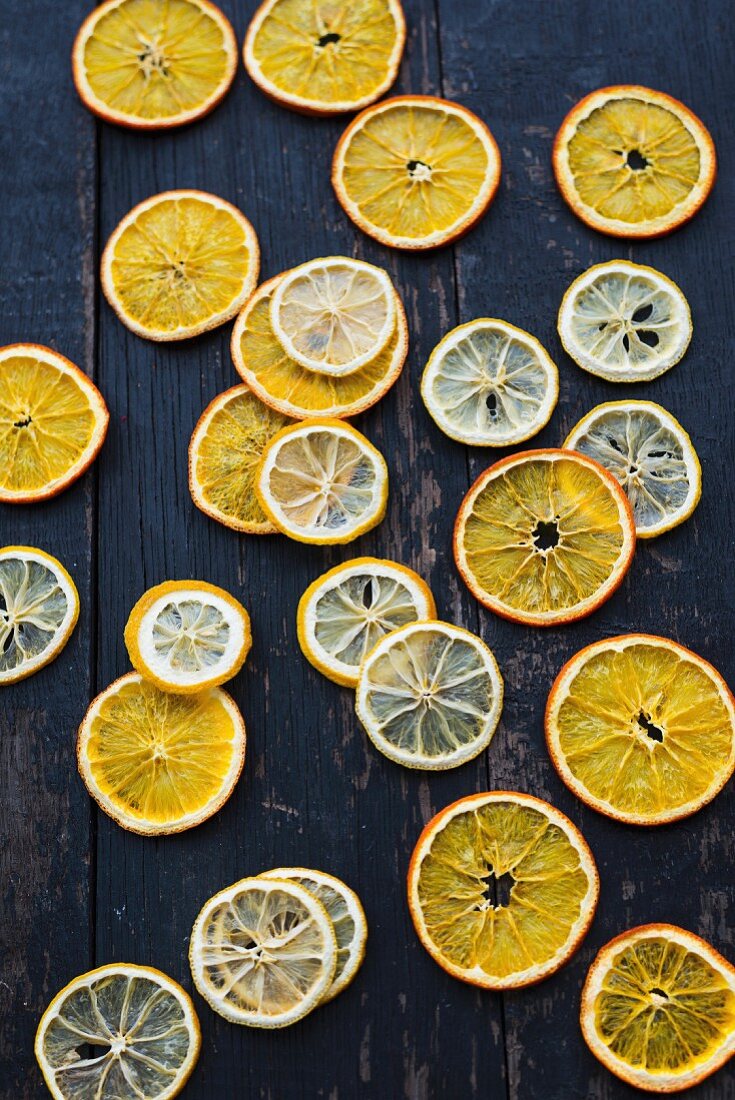 Dried citrus fruit slices on a wooden background