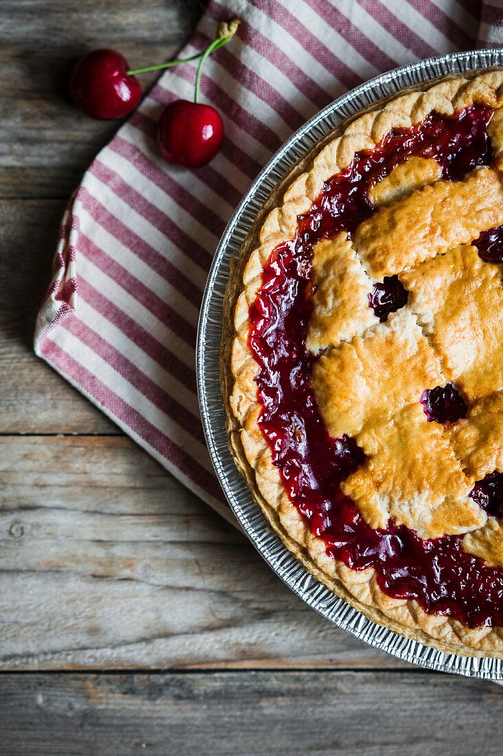 Homemade cherry pie on a rustic surface