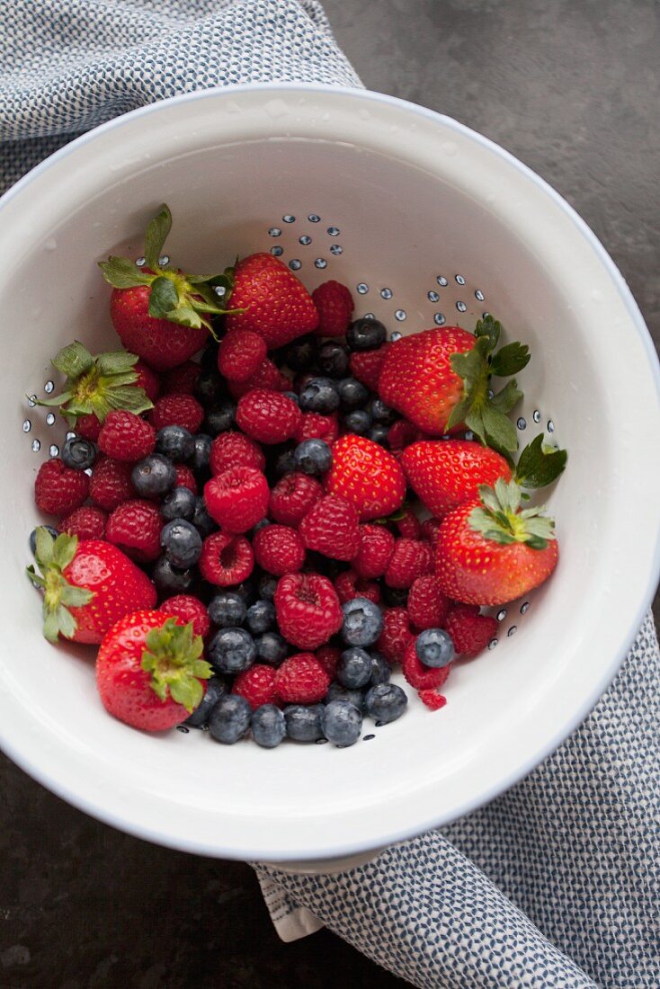 Freshly washed berries in a colander (seen from above)