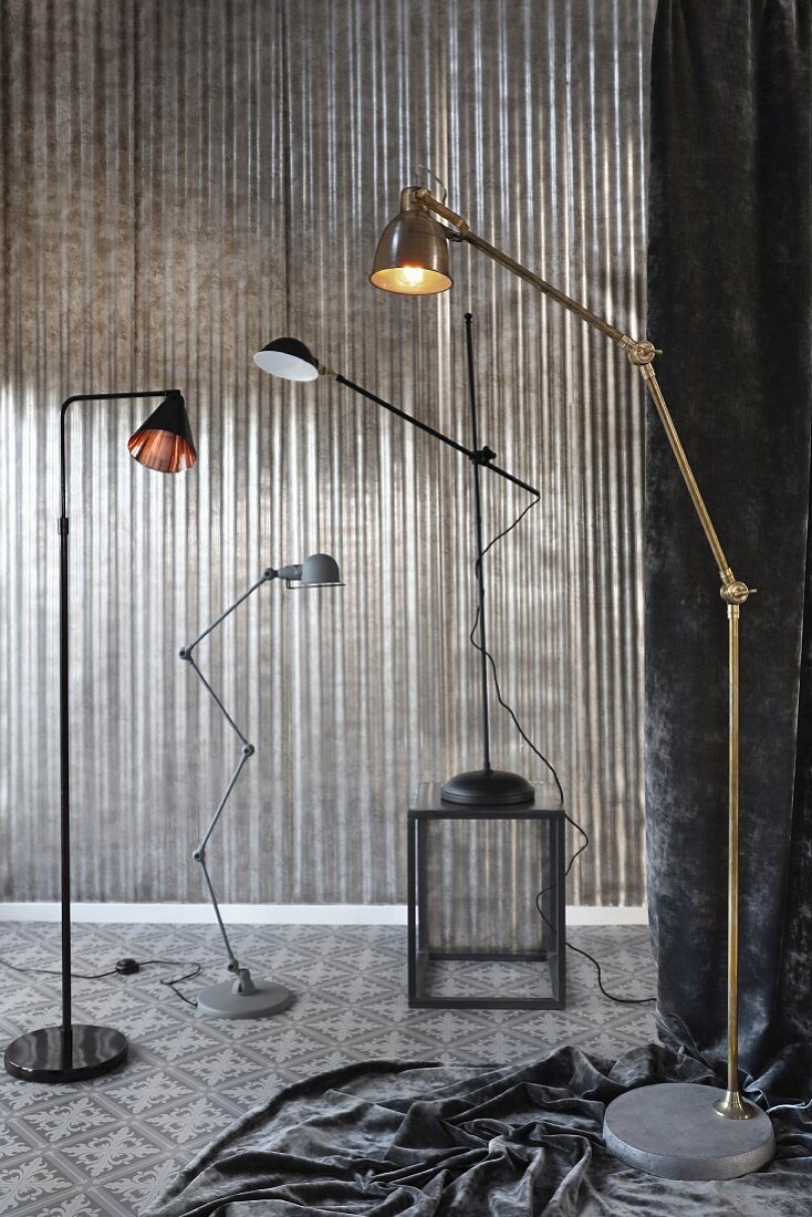 Arrangement of several standard lamps in grey interior