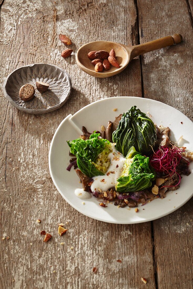 Glazed savoy cabbage bites with fried oyster mushrooms and smoked almonds