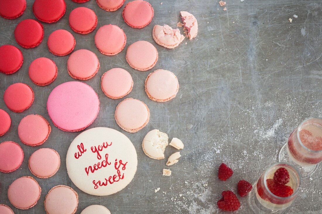 Various pink macaroons and champagne with raspberries