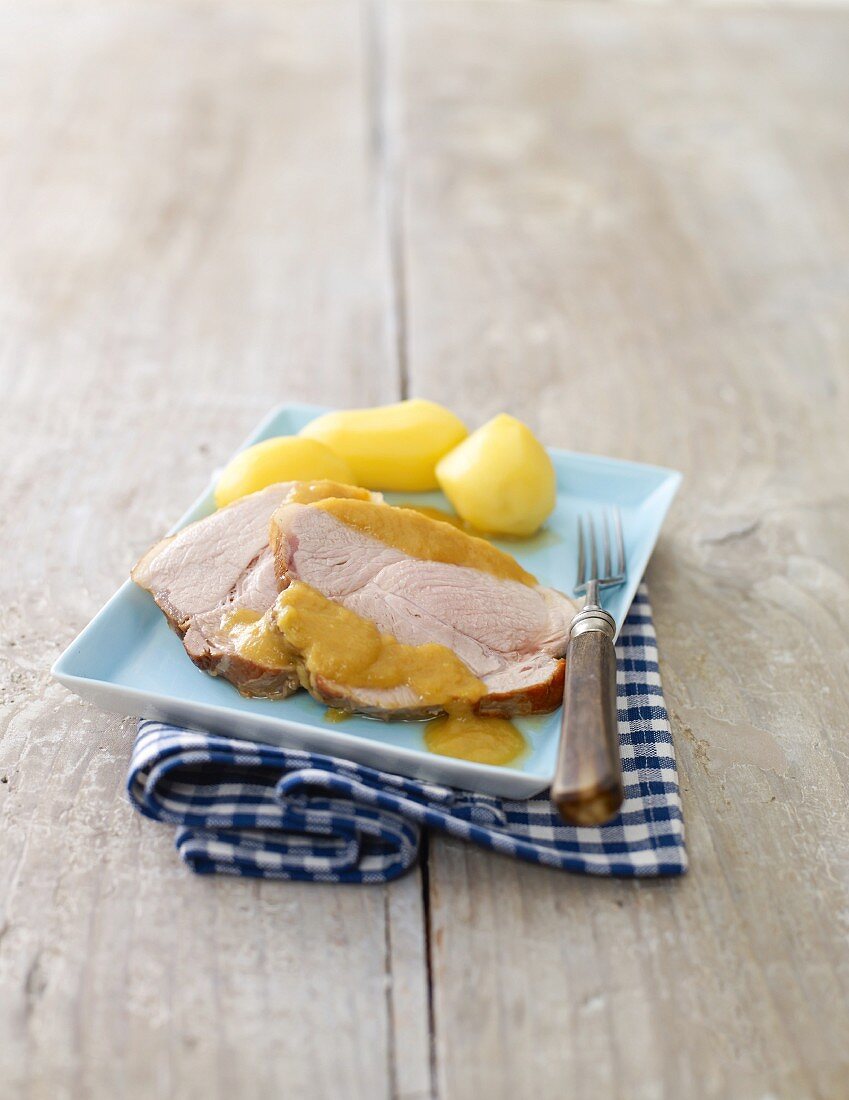 Roast pork with gravy and new potatoes