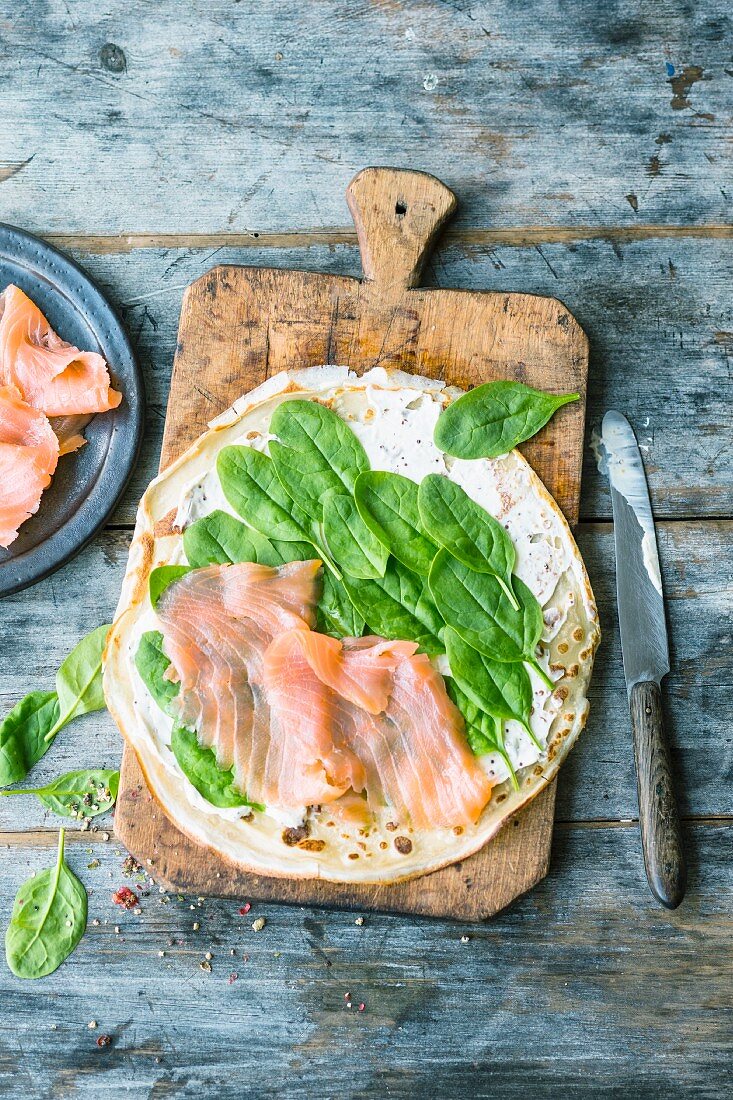 A crepe topped with salmon and spinach