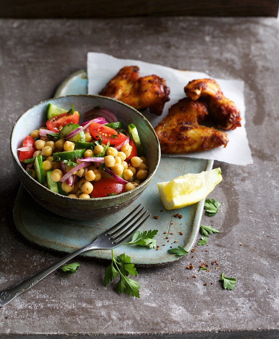 Spicy chickpea salad with coloured vegetables as a side dish for chicken