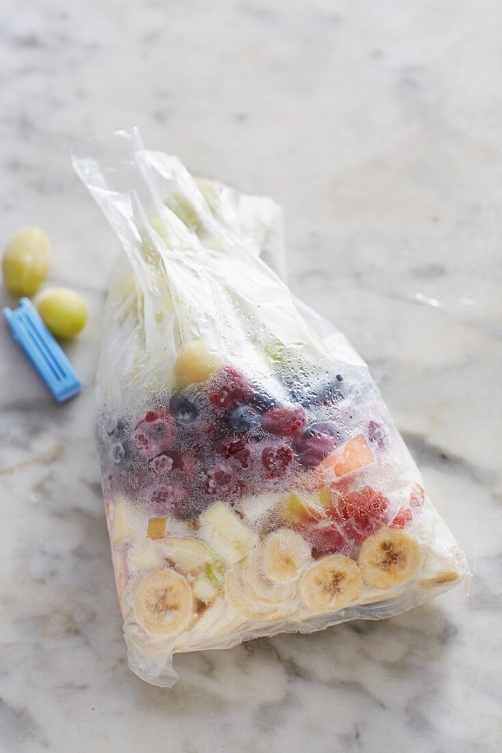 Frozen fruits in a freezer bag for making smoothies