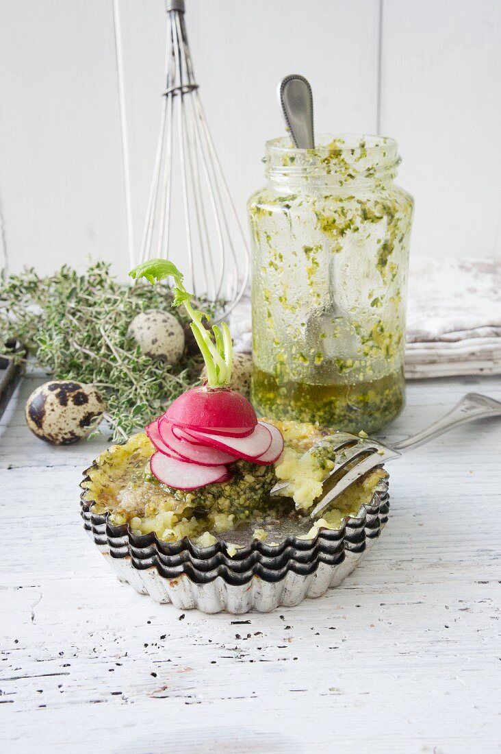 Potato and Parmesan fritters garnished with radishes in a baking tin