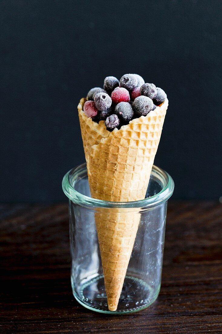 Frozen forest berries in an ice cream cone