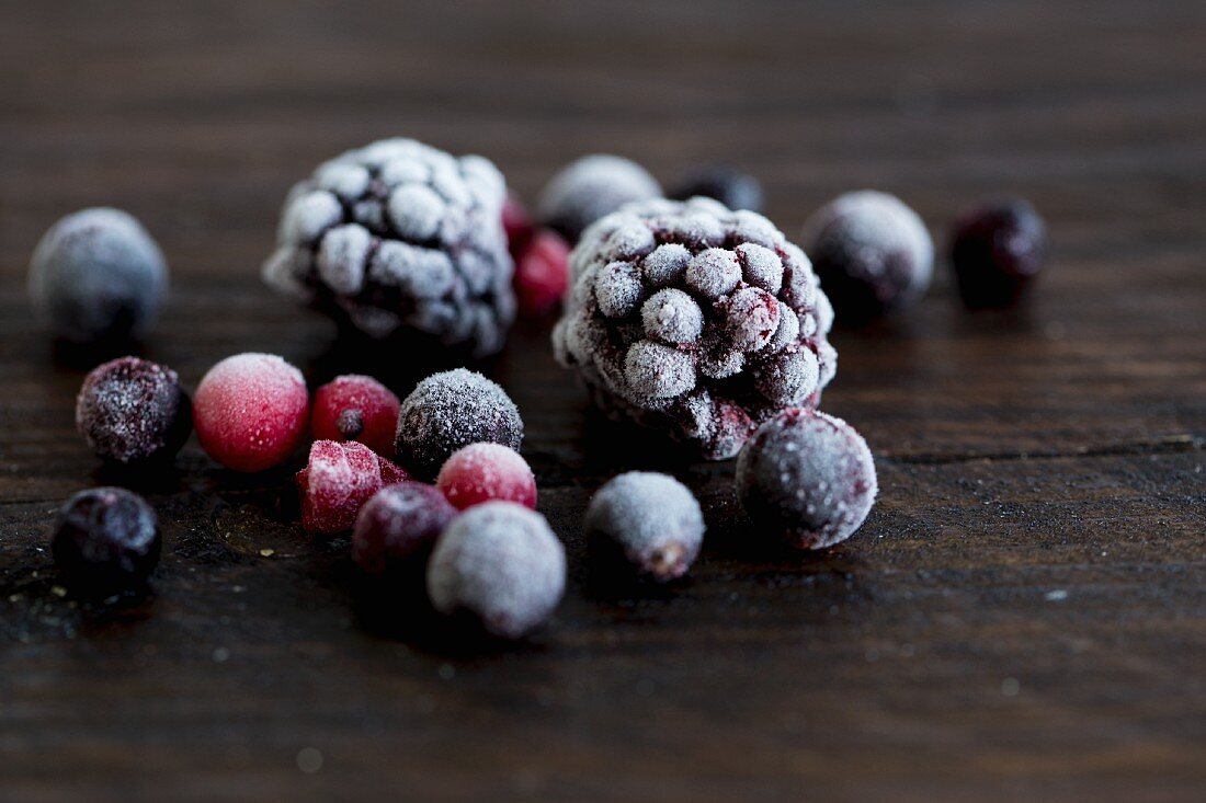 Frozen forest berries on a wooden surface