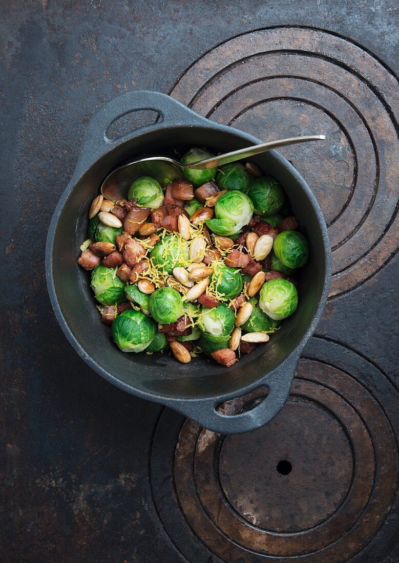 Steamed brussels sprouts with bacon, roasted almonds and grated lemon zest