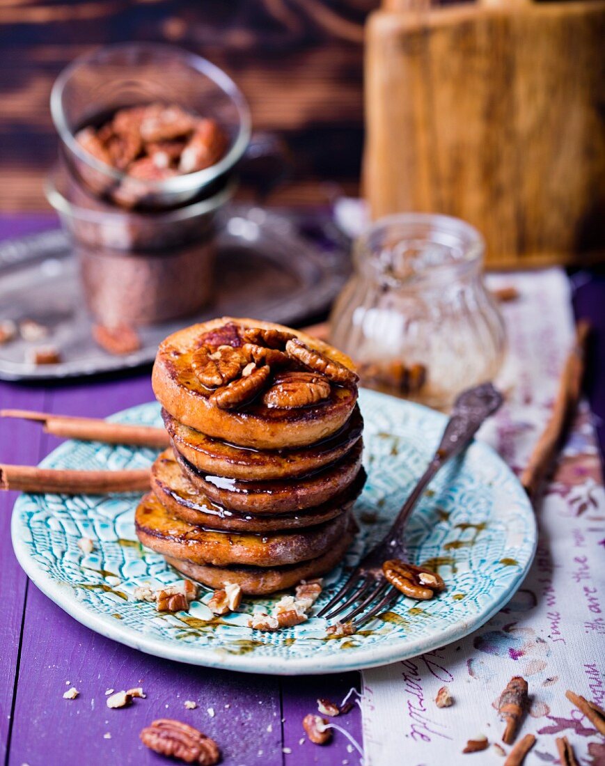 A stack of French toast with pecan nuts