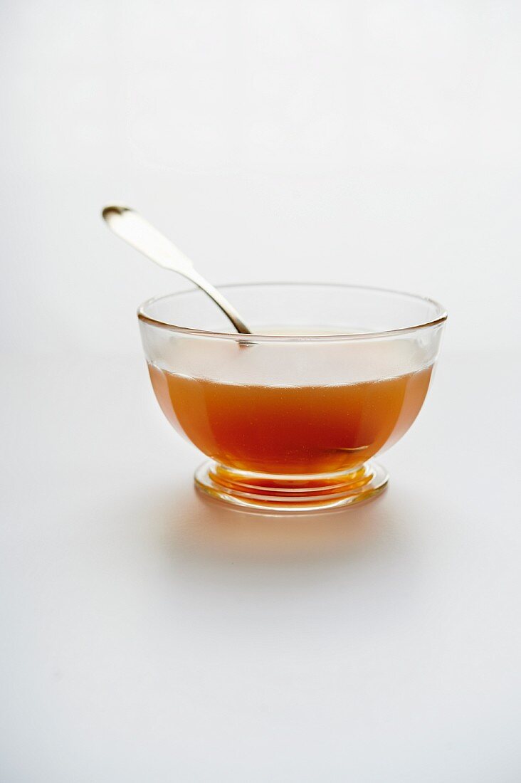 Beef bone broth in a glass bowl