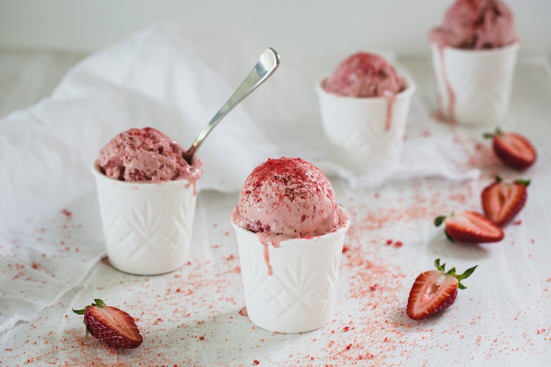 Homemade strawberry ice cream in tubs