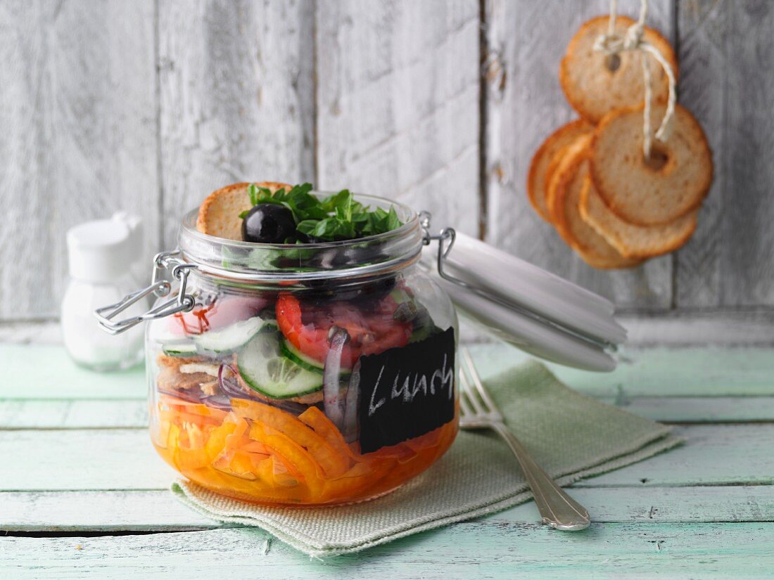 Layered spicy vegetable and bread salad in a jar