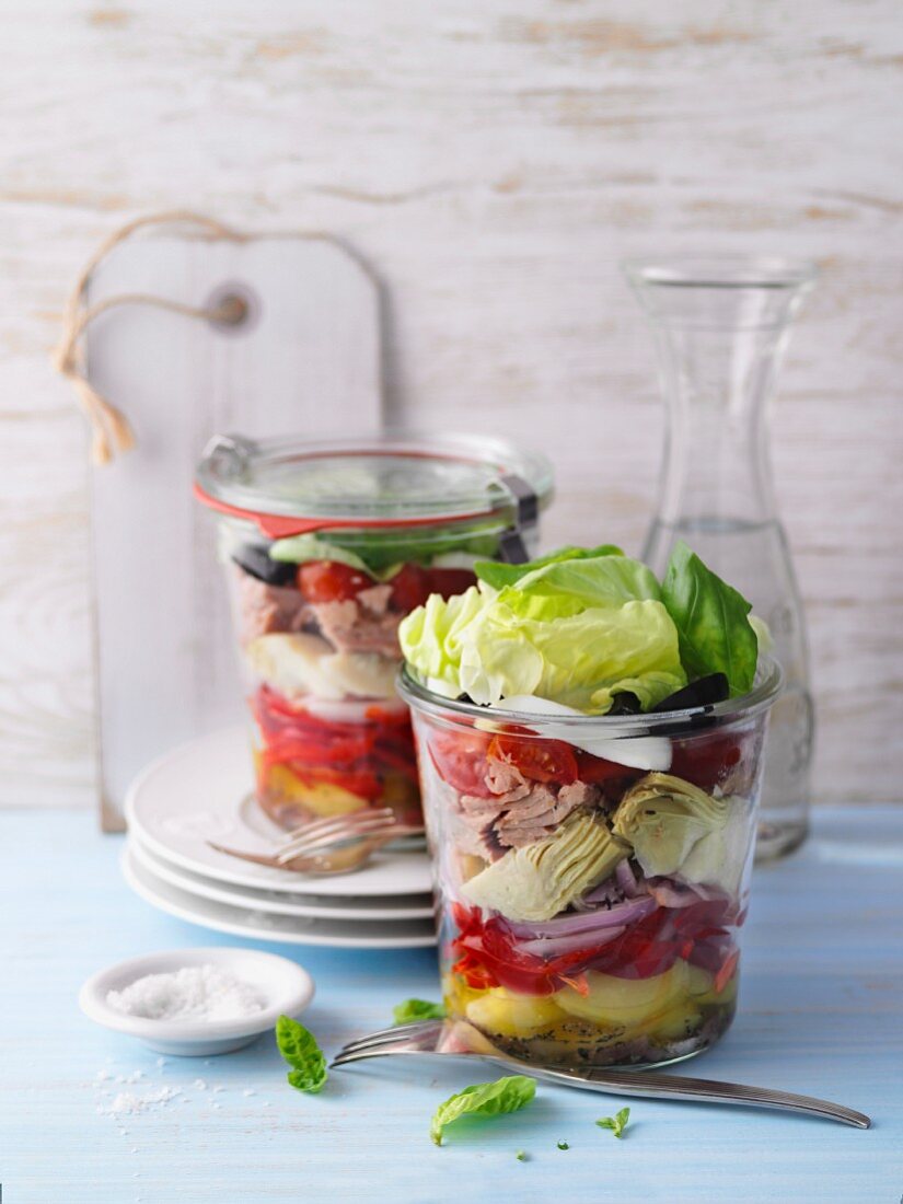 Layered salad Niçoise with tuna fish in jars