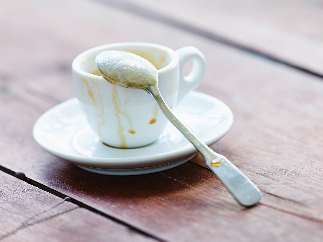 An empty espresso cup with a spoon